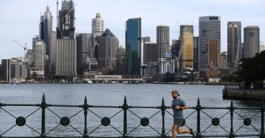 A man jogs backdropped by the skyline in Sydney, Australia, Sept. 2, 2020. (EPA Photo)