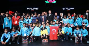 President Recep Tayyip Erdoğan poses with Romani citizens at a convention at the Presidential Complex, in the capital Ankara, Türkiye, April 12, 2018. (İHA Photo)