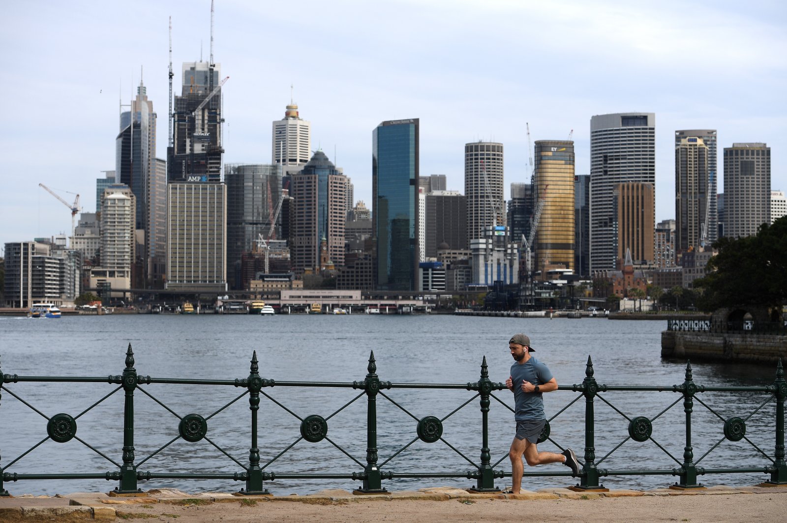 A man jogs backdropped by the skyline in Sydney, Australia, Sept. 2, 2020. (EPA Photo)