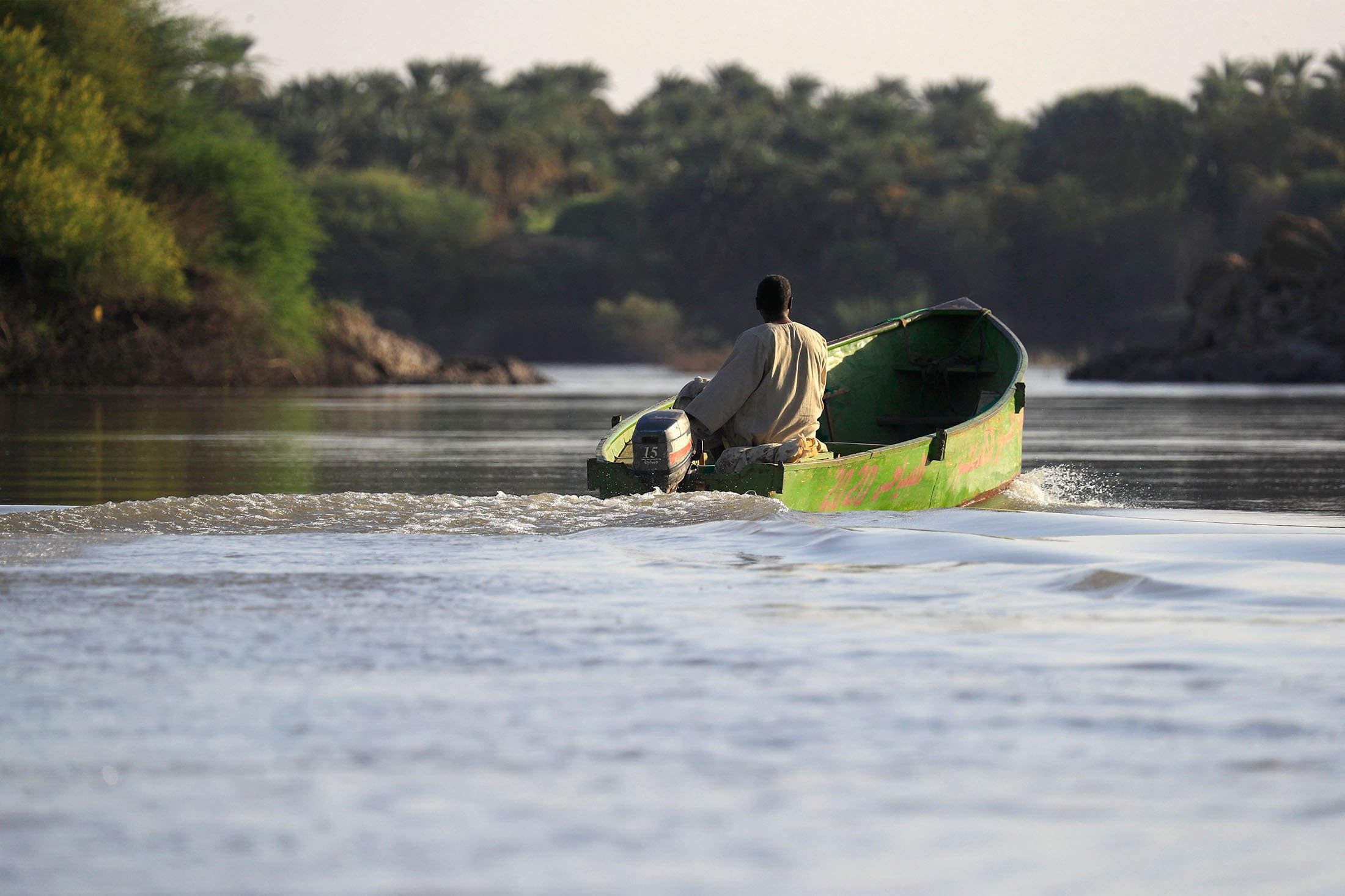 A man rides a boat in the Nile river in Northern State, near the Kassinger Islands, Sudan, Oct. 28, 2022. (AFP Photo)