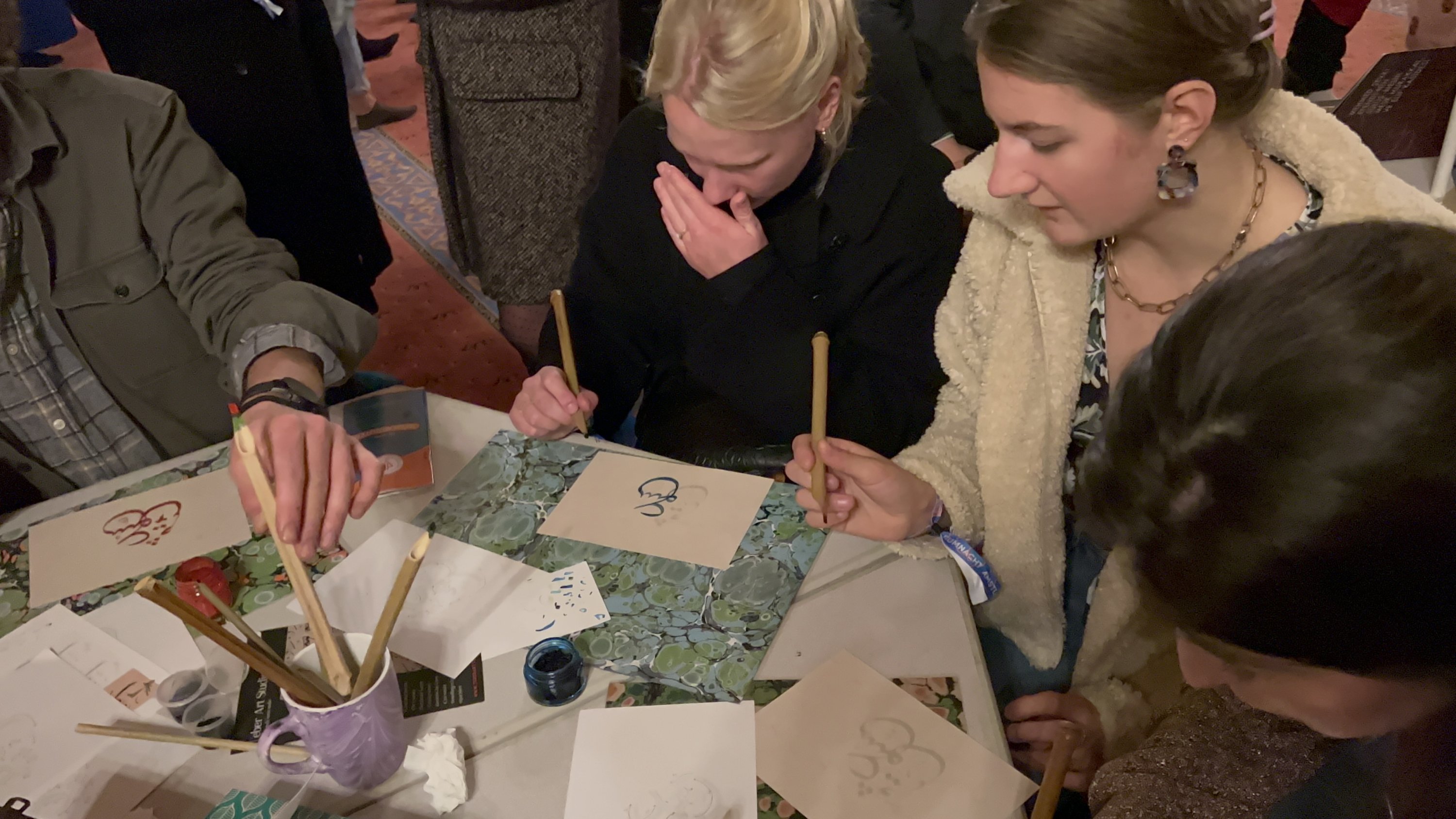 Visitors learn about marbling art at the Fatih Mosque in Amsterdam as part of the 
