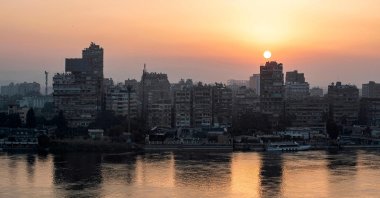 The sun rises behind the skyline of capital Cairo&#039;s Nile river island of Manial, Egypt, Nov. 3, 2022. (AFP Photo)