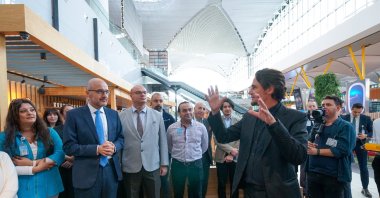 Exhibition curator Marcus Graf describes the "Dreams Under the Viaduct" in Istanbul Airport, Türkiye, Oct. 27, 2022. (Photo courtesy of IGART)