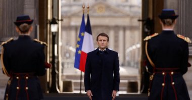 French President Emmanuel Macron stands in front of the coffin of late French abstract painter Pierre Soulages during a tribute ceremony at the Cour Carrée of the Louvre museum in Paris, France, Nov. 2, 2022. (AFP Photo)