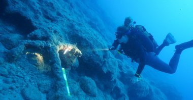 A member of the exploration team examines remnants from a shipwreck, in Antalya, Türkiye, Nov. 6, 2022. (AA Photo)