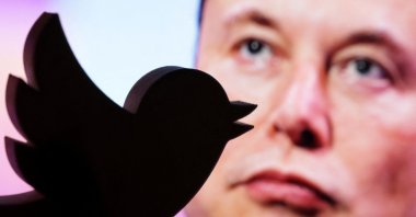 A 3D-printed Twitter logo is seen in front of a displayed photo of Elon Musk in this illustration taken Oct. 27, 2022. (Reuters Photo)