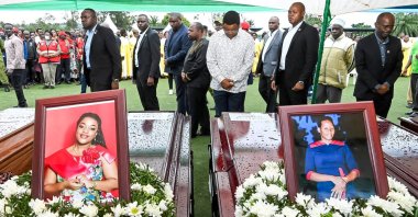 Tanzanian Prime Minister Kassim Majaliwa (C) stands in front of the coffins as he pays homage to the victims of a plane crash, Bukoba, Tanzania, Nov. 7, 2022. (Reuters Photo)