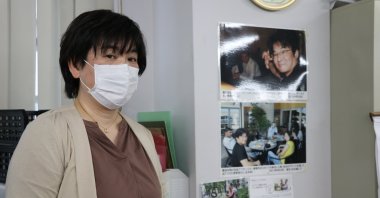 Otsuka Asako speaks next to photo and mementos of Atsushi Miyazaki, in Tokyo, Japan, Nov. 8, 2022. (AA Photo) 