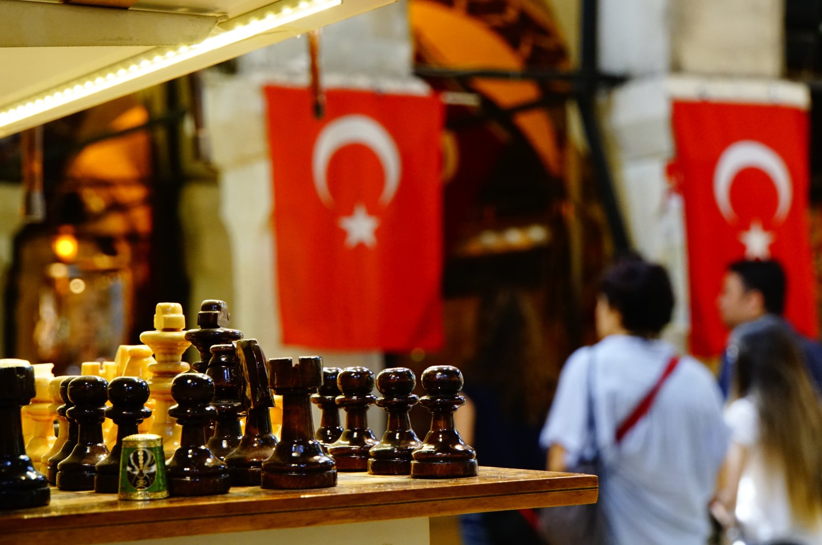 A chessboard is seen in front of Turkish flags hanging in the background. (Getty Images Photo)