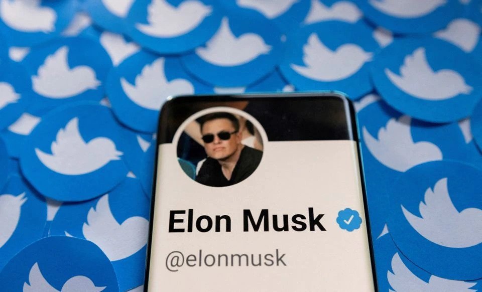 Elon Musk&#039;s Twitter profile is seen on a smartphone placed on printed Twitter logos in this picture illustration taken April 28, 2022. (Reuters Illustration)
