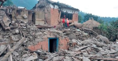 People stand outside the ruins of collapsed houses after an earthquake, Doti, Nepal, Nov. 9, 2022. (Reuters Photo)