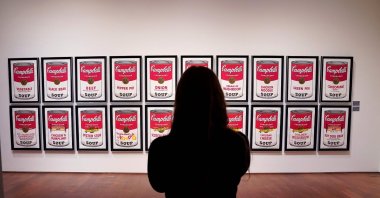 A woman looks at Andy Warhol’s “Campbell's Soup 1&amp;2” at Sotheby’s New York, U.S., Oct. 25, 2022. (AFP Photo)