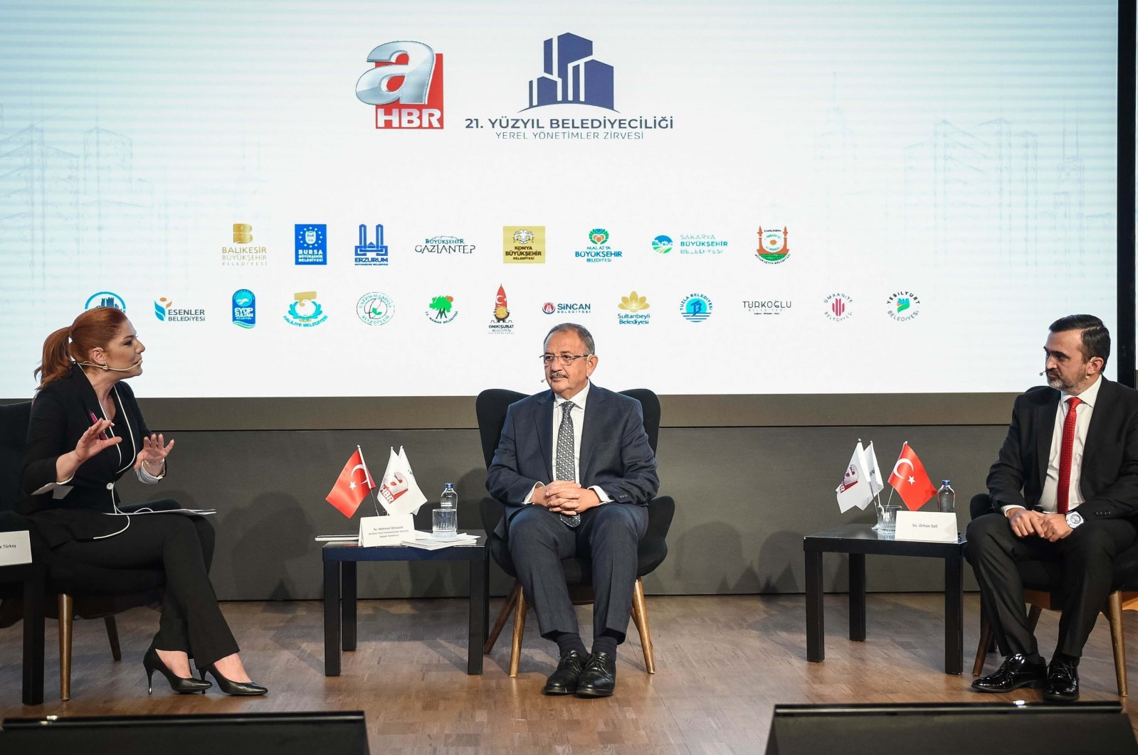 (L-R) A Haber Presenter Merve Türkay, Türkiye’s ruling Justice and Development Party (AK Party) Chairperson of Local Administrations Mehmet Özhaseki, and A News Editor-in-Chief Orhan Sali at the “21st Century Municipalism: Local Administrations Summit” held in Istanbul, Türkiye, Nov. 7, 2022. (Courtesy of A Haber)