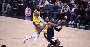 Los Angeles Clippers guard Paul George gets fouled by Los Angeles Lakers forward LeBron James during the NBA game between the Los Angeles Lakers and the Los Angeles Clippers at Crypto.com Arena, Los Angeles, California, U.S., Nov. 9, 2022. (Getty Images Photo)