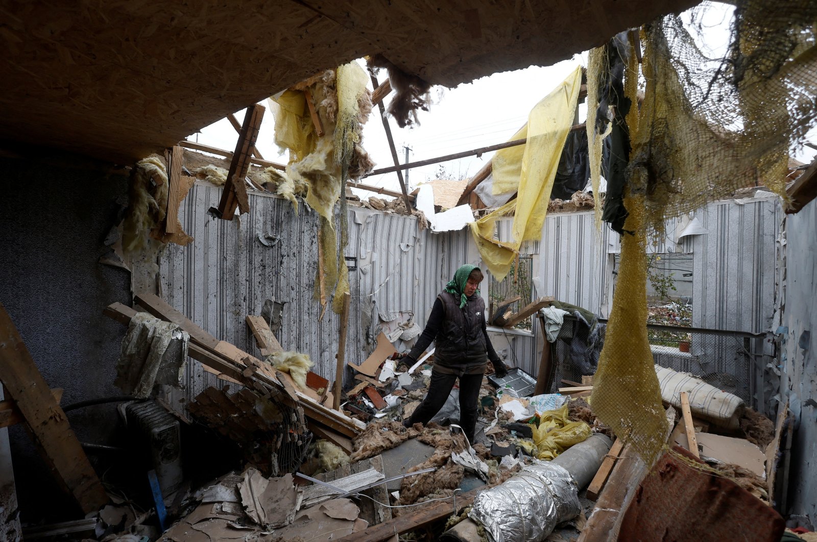Local resident Serhii Tamara removes debris inside her son&#039;s house that was destroyed during a Russian military attack in the village of Novooleksandrivka, in Kherson region, Ukraine, Nov. 9, 2022.  (REUTERS Photo)
