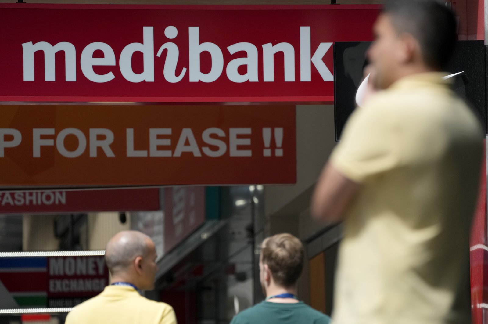 People walk past a Medibank branch in Sydney, Australia, Oct. 26, 2022. (AP Photo)