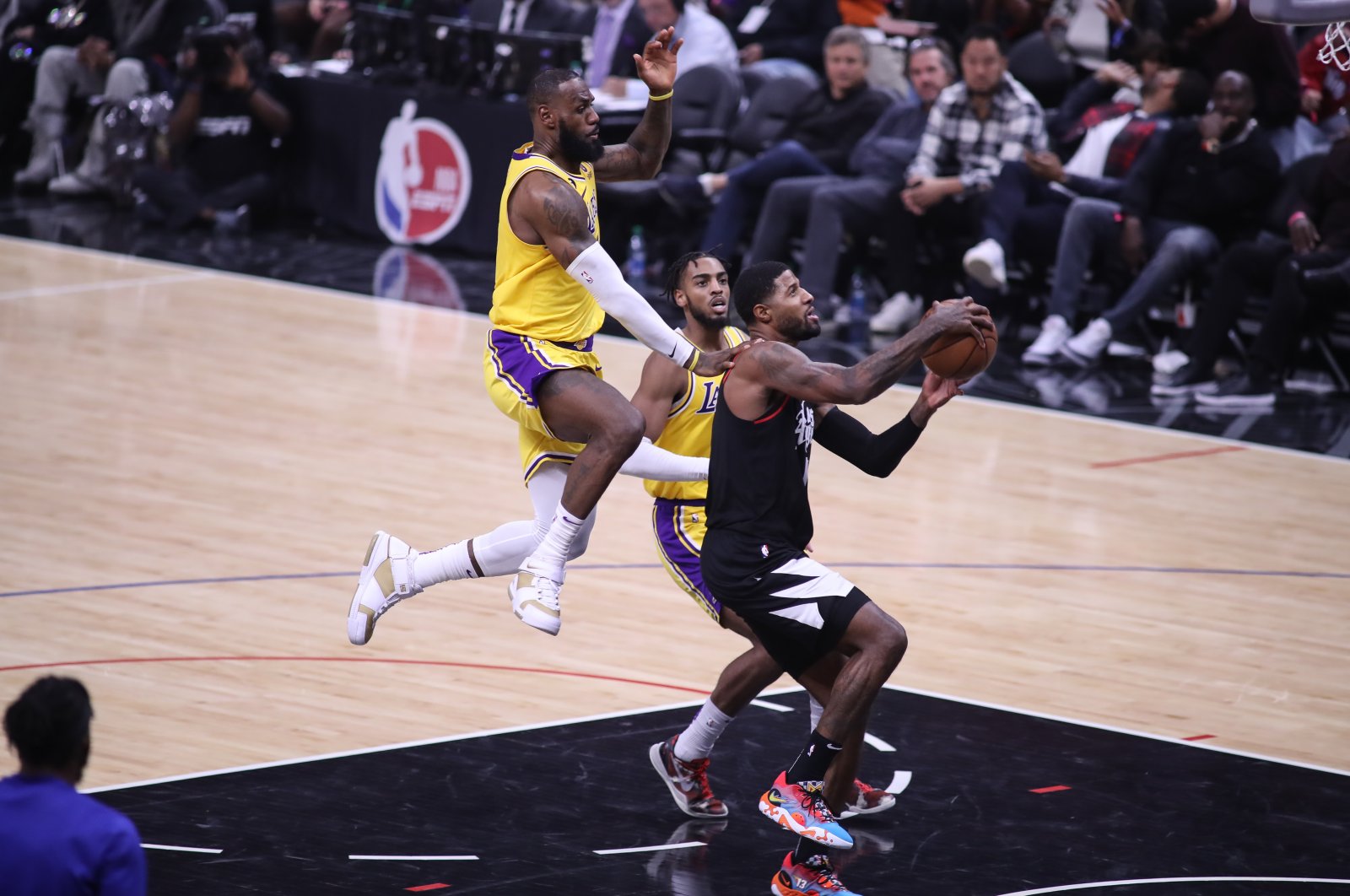 Los Angeles Clippers guard Paul George gets fouled by Los Angeles Lakers forward LeBron James during the NBA game between the Los Angeles Lakers and the Los Angeles Clippers at Crypto.com Arena, Los Angeles, California, U.S., Nov. 9, 2022. (Getty Images Photo)