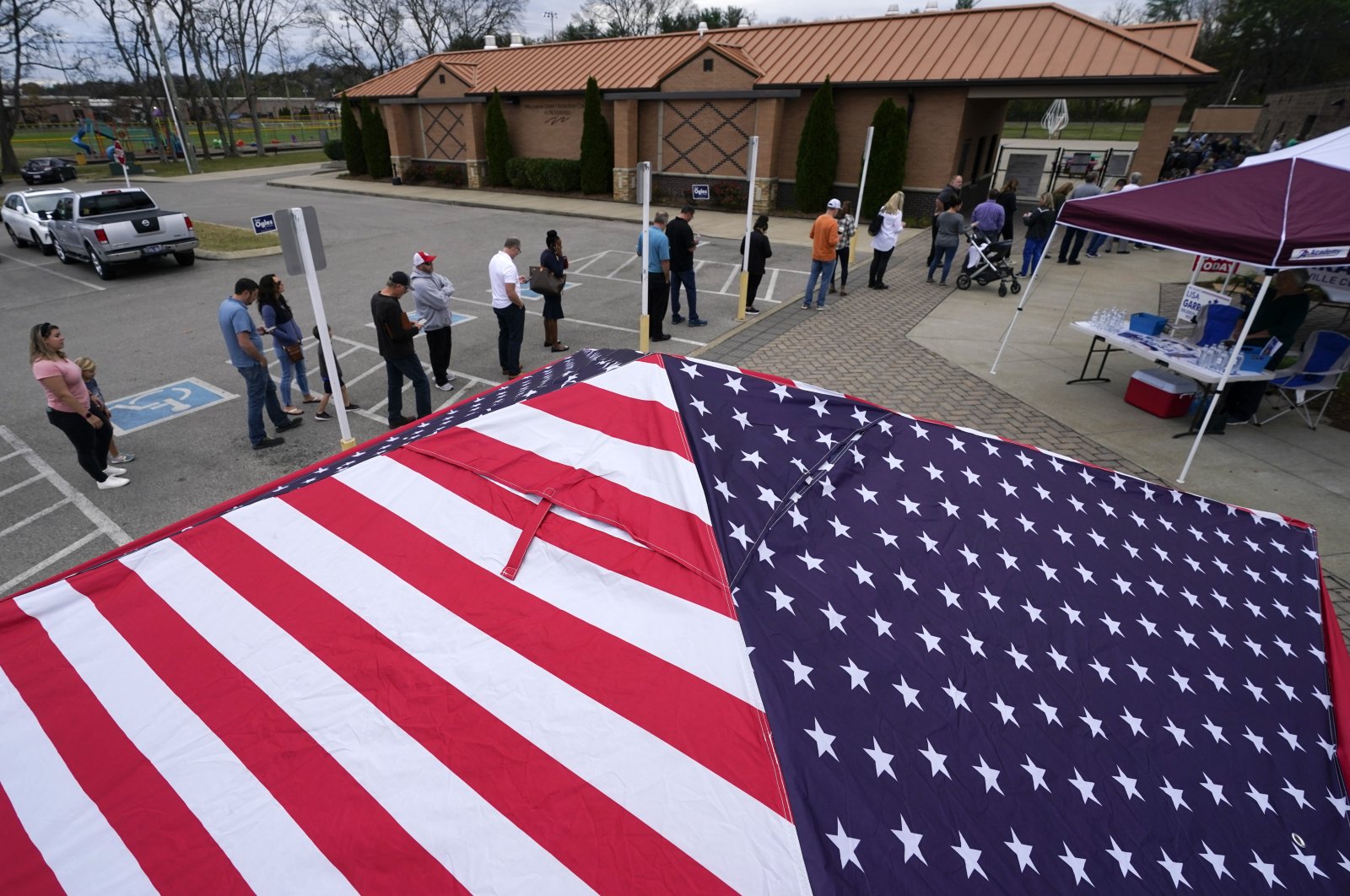 People line up to vote near tents set up by candidates&#039; supporters, Nolensville, Tennessee, U.S., Nov. 8, 2022. (AP Photo)