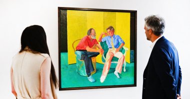 Christie's senior specialist and senior vice president views "The Conversation" by David Hockney on display at Christie's Los Angeles in Beverly Hills, California, U.S., Oct. 12, 2022. (AFP Photo)