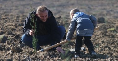 A man and a boy plant a sapling on the occasion of National Forestation Day, in Yalova, northwestern Türkiye, Nov. 11, 2022. (AA Photo) 