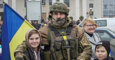 Local residents take a photo with Ukrainian soldiers as they celebrate after Russia's retreat from Kherson, in central Kherson, Ukraine, Nov. 12, 2022. (Reuters Photo)