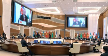 President Recep Tayyip Erdogan (on screen) speaks during the 9th Summit of the Organisation of Turkic States (OTS) at the Eternal City Convention Center, Samarkand, Uzbekistan, Nov. 11, 2022. (Handout by Press Office of the Presidency of Türkiye via AFP)