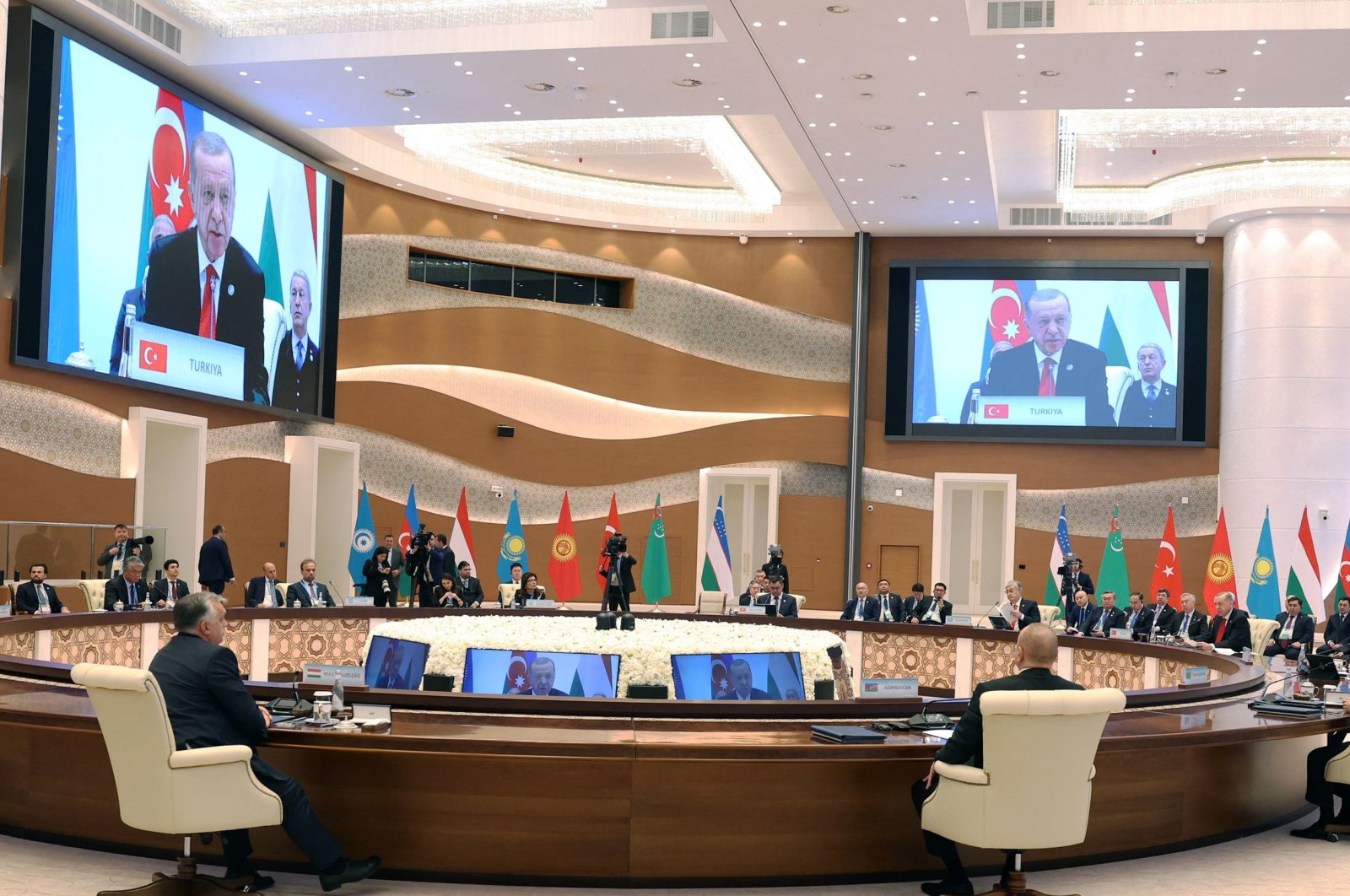 President Recep Tayyip Erdogan (on screen) speaks during the 9th Summit of the Organisation of Turkic States (OTS) at the Eternal City Convention Center, Samarkand, Uzbekistan, Nov. 11, 2022. (Handout by Press Office of the Presidency of Türkiye via AFP)