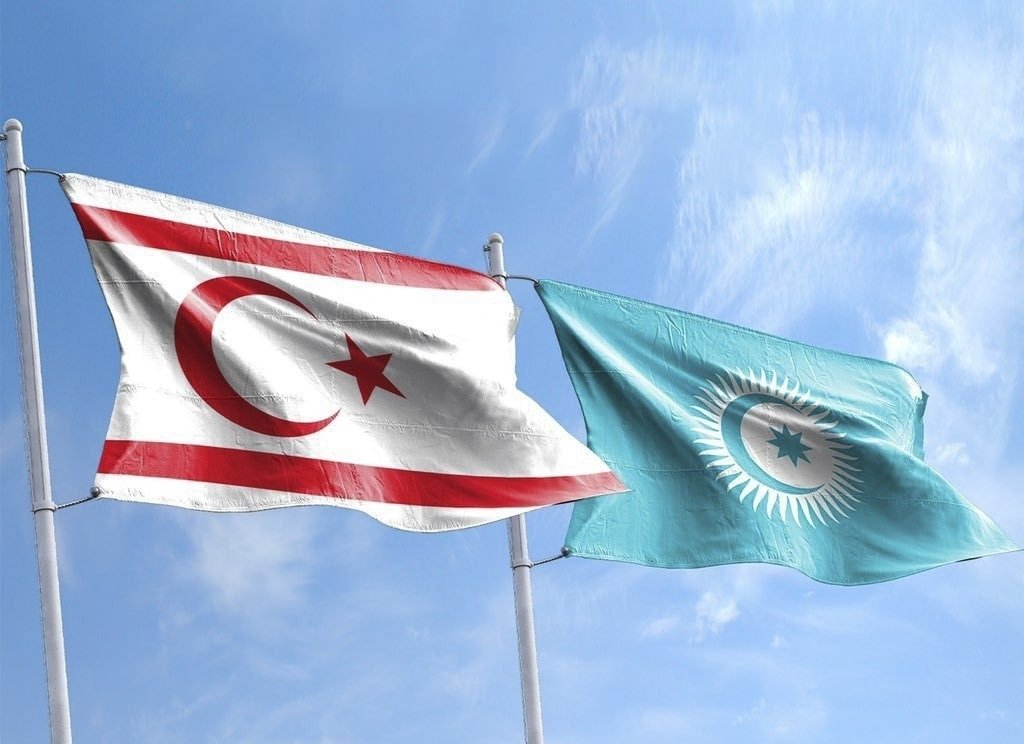 A brochure shows the flags of the Turkish Republic of Northern Cyprus (TRNC) (L) and the Organization of Turkic States together, Nov. 11, 2022. (DHA Photo)