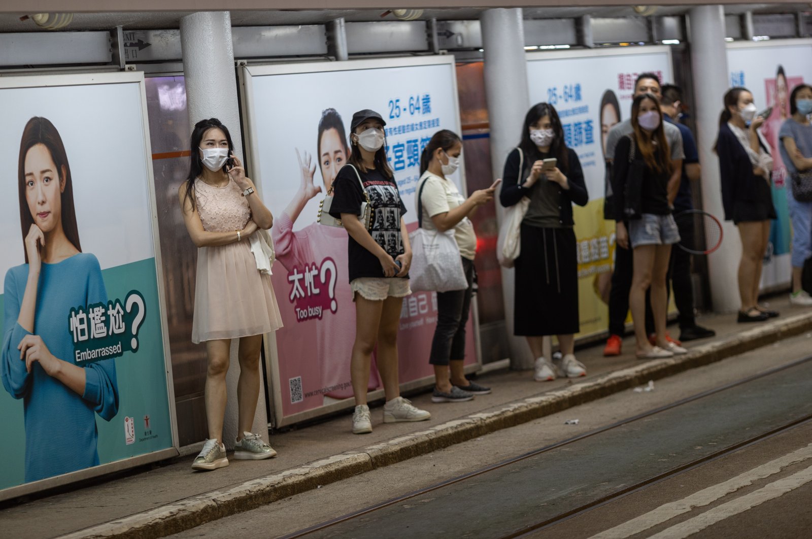 People wear masks at a tramway stop in Wanchai district, Hong Kong, China, Oct. 14, 2022. (EPA Photo)