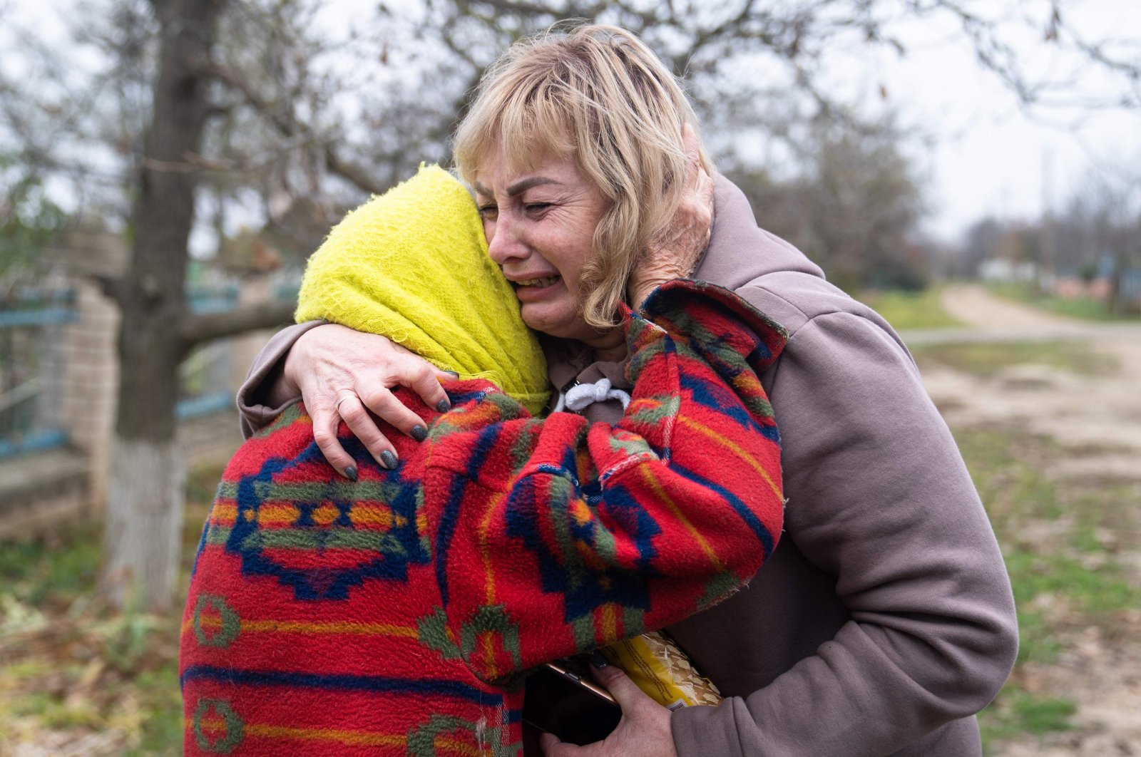 Svitlana Striletska (R) hugs Galina Timofievna (L) in the liberated village of Pravdyne, Kherson region, Ukraine, Nov. 12, 2022 (AFP Photo)