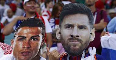 Fans wear masks with the face of Cristiano Ronaldo (L) and Lionel Messi at the 2018 World Cup, Sochi, Russia, July 7, 2018. (AP Photo)