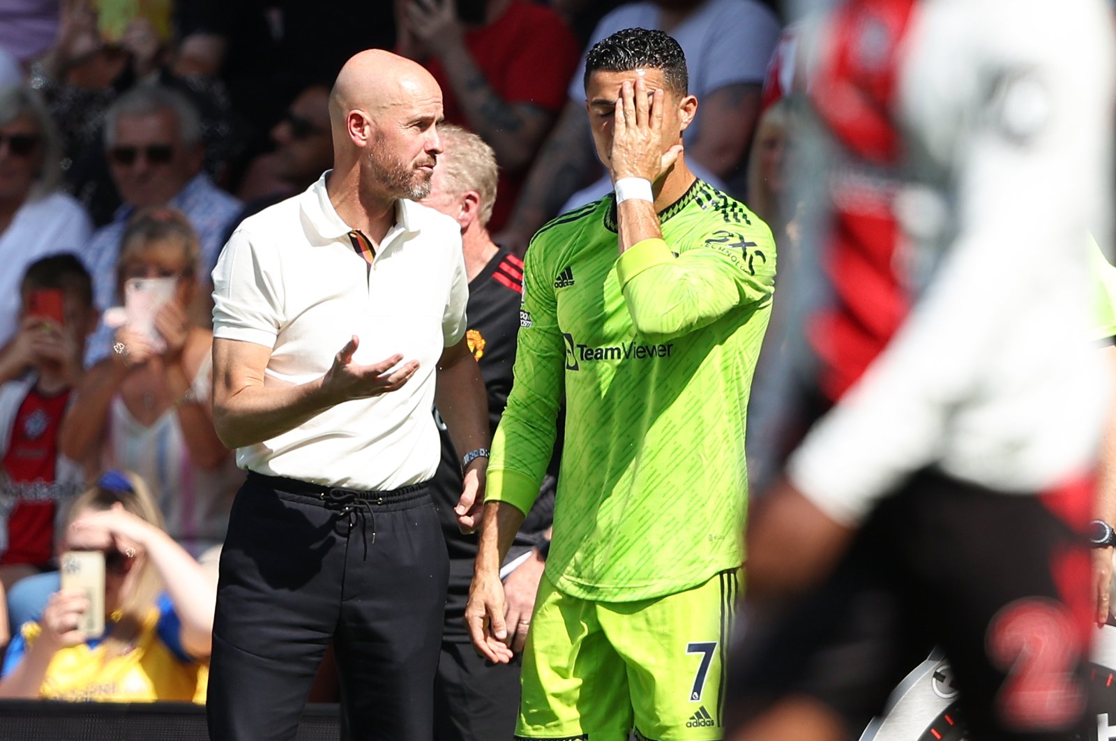 Erik ten Hag the manager and head coach of Manchester United, and Cristiano Ronaldo of Manchester United speak during a Premier League match, Southampton, U.K., August 2022.  (Getty Images)