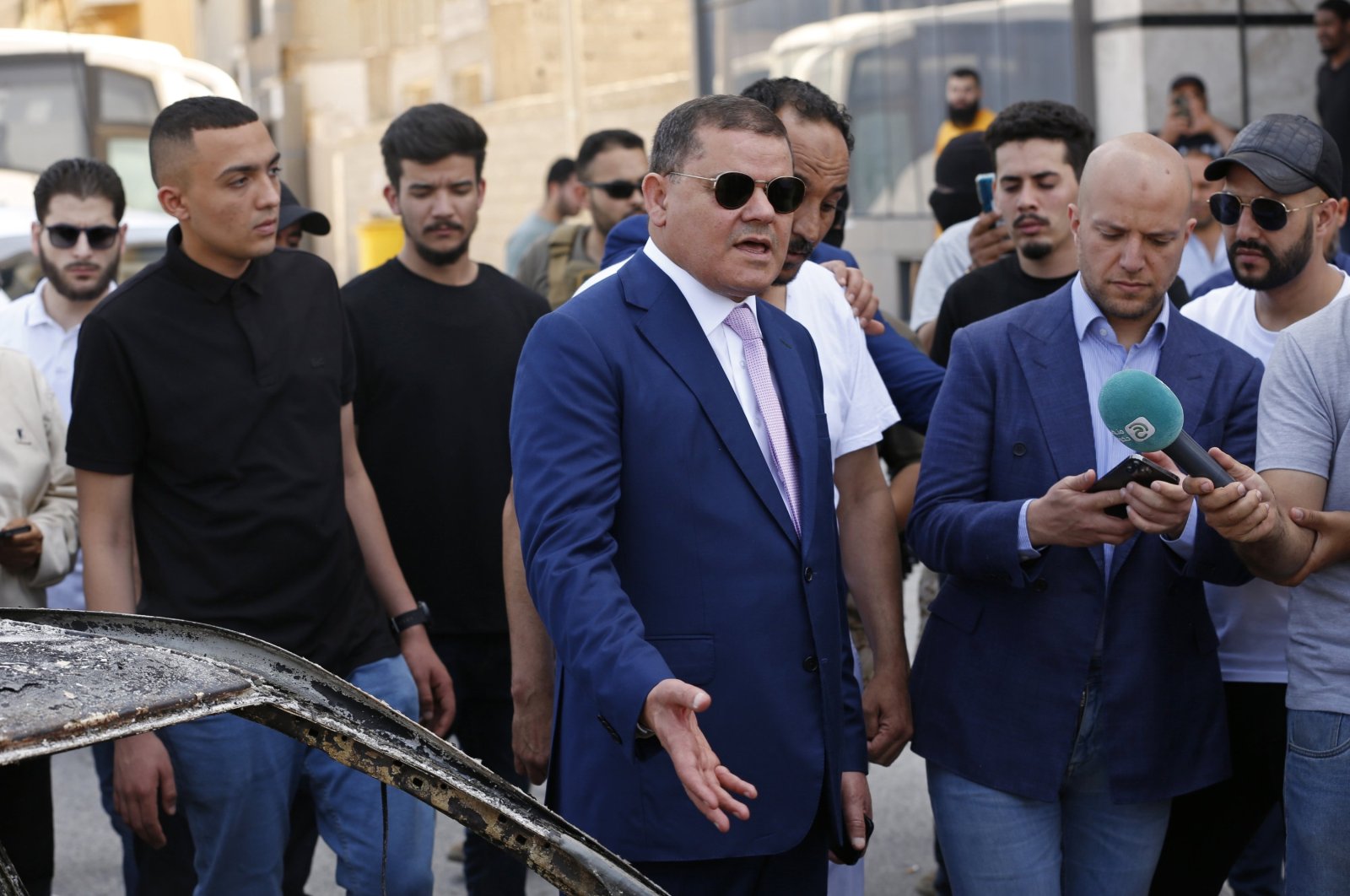 Abdul Hamid Dbeibah, one of Libya’s two rival prime ministers (C) speaks to residents as he visits a Tripoli neighborhood after competing militias fought there, in Tripoli, Libya, May 17, 2022. (AP File Photo)