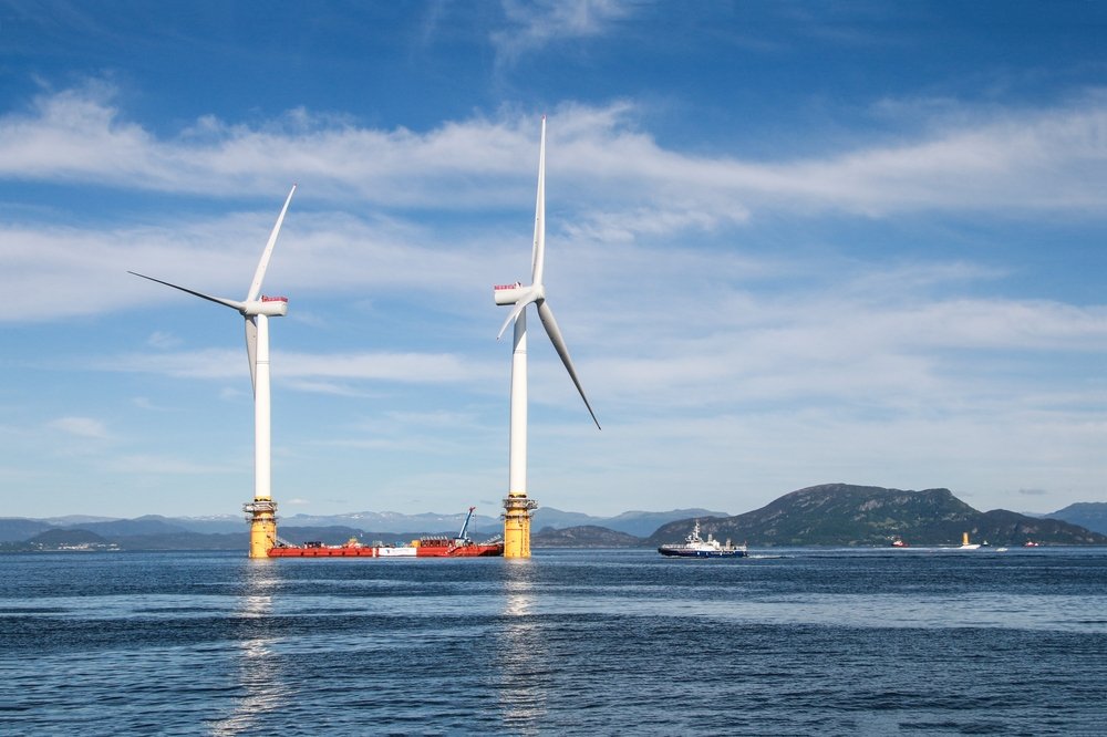 Two of the five floating wind turbines being prepared to be sent to Scotland wait off the coast of Stord, Norway, June 27, 2017. (Shutterstock Photo)