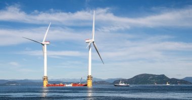 Two of the five floating wind turbines being prepared to be sent to Scotland wait off the coast of Stord, Norway, June 27, 2017. (Shutterstock Photo)