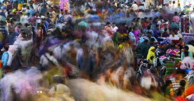 People move through a market in Mumbai, India, Nov. 12, 2022. (AP Photo)