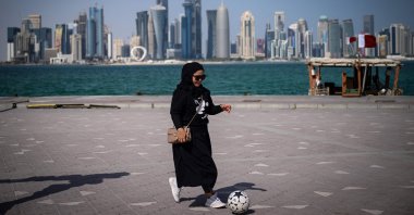 A fan plays football along the waterfront in Doha ahead of the Qatar 2022 World Cup football tournament, Nov. 14, 2022. (AFP Photo)