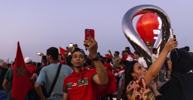 Fans of Morocco take photos next to the Hublot World Cup Official countdown watch at Doha Corniche ahead of the FIFA World Cup Qatar 2022. Doha, Qatar, Nov. 14, 2022. (Getty Images Photo)