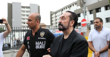 Police officers escort Adnan Oktar and others after their arrest, in Istanbul, Türkiye, July 19, 2018. (AA Photo)