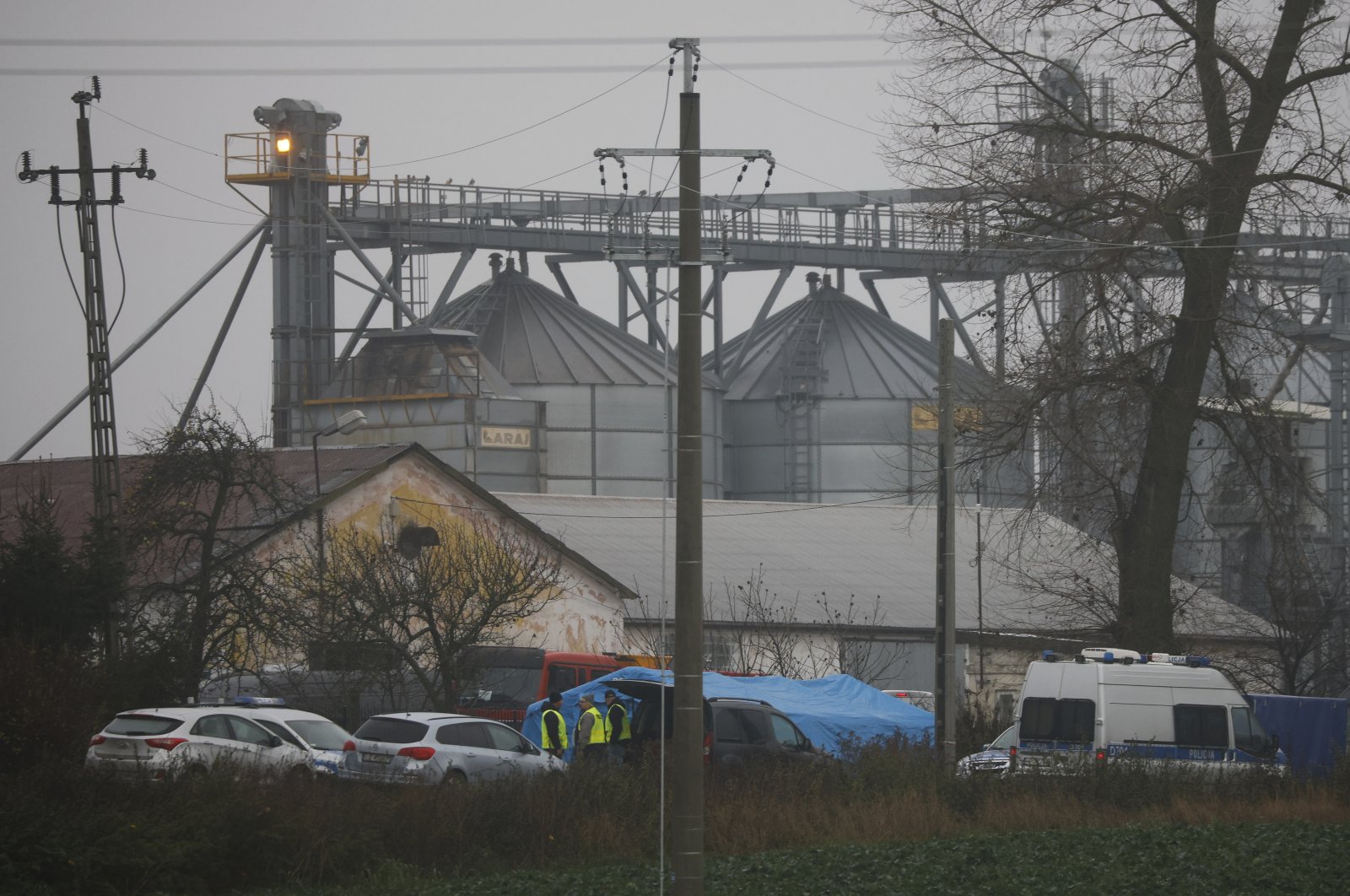 Police officers work outside a grain depot where two people were killed in a missile strike, Przewodow, Poland, Nov. 16, 2022. (AP Photo)