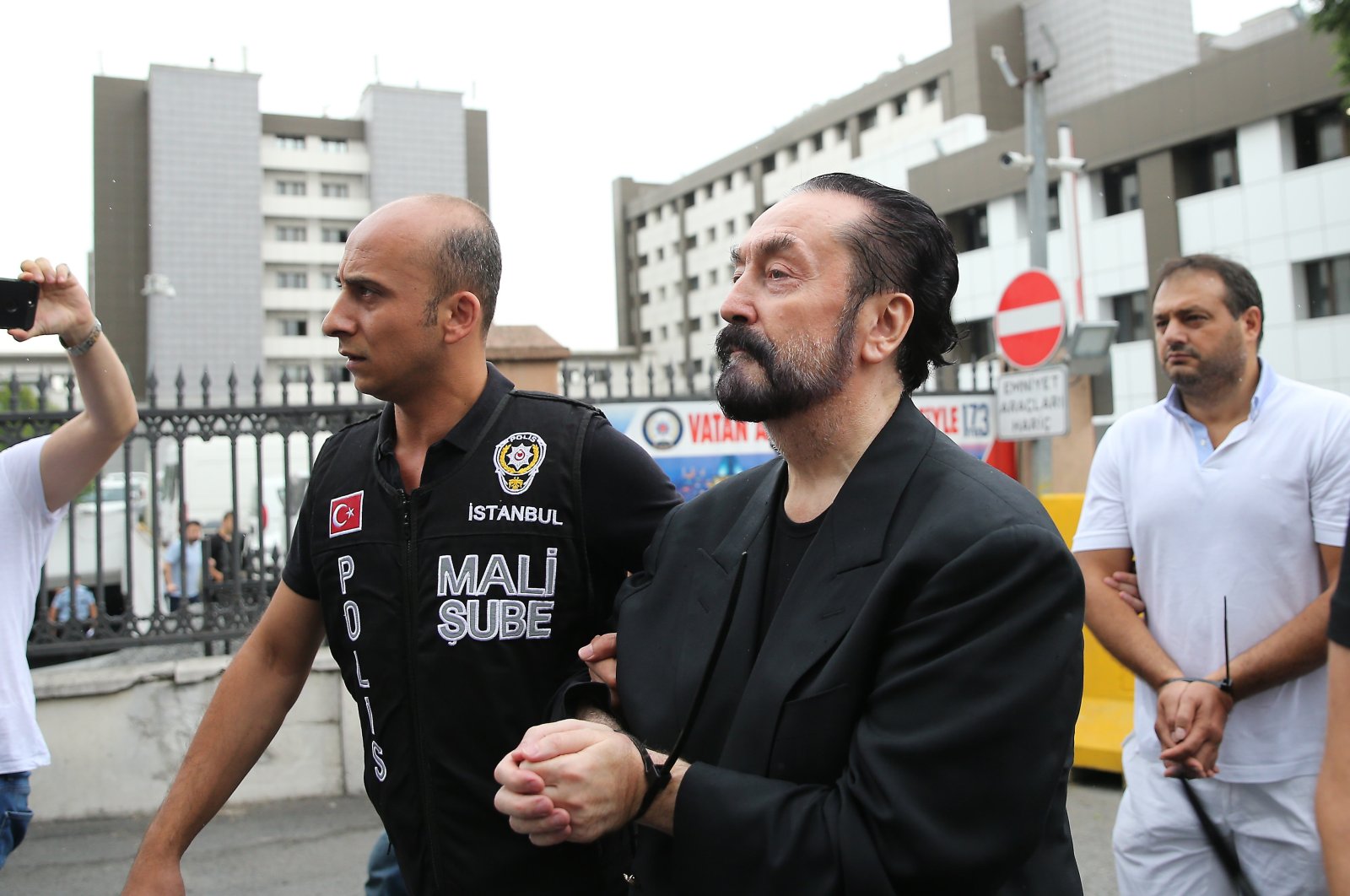 Police officers escort Adnan Oktar and others after their arrest, in Istanbul, Türkiye, July 19, 2018. (AA Photo)
