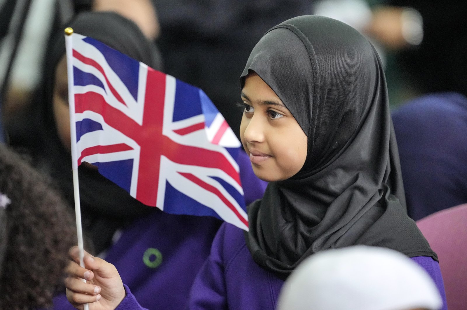 A girl waves a U.K. flag during a national Muslim memorial for the late Queen Elizabeth II, London, U.K., Sept. 15, 2022. (AP Photo)