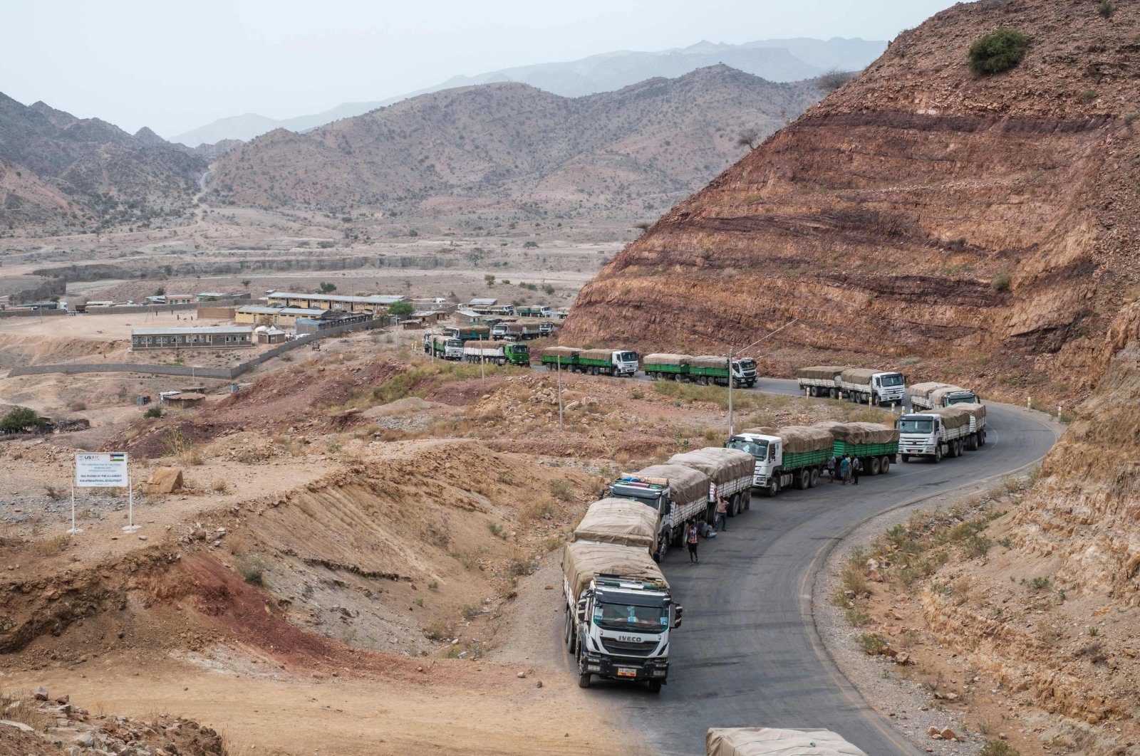 In this file photo taken on June 9, 2022, A convoy of trucks part of a convoy of the World Food Programme (WFP) on their way to Tigray are seen in the village of Erebti, Ethiopia. (AFP Photo)