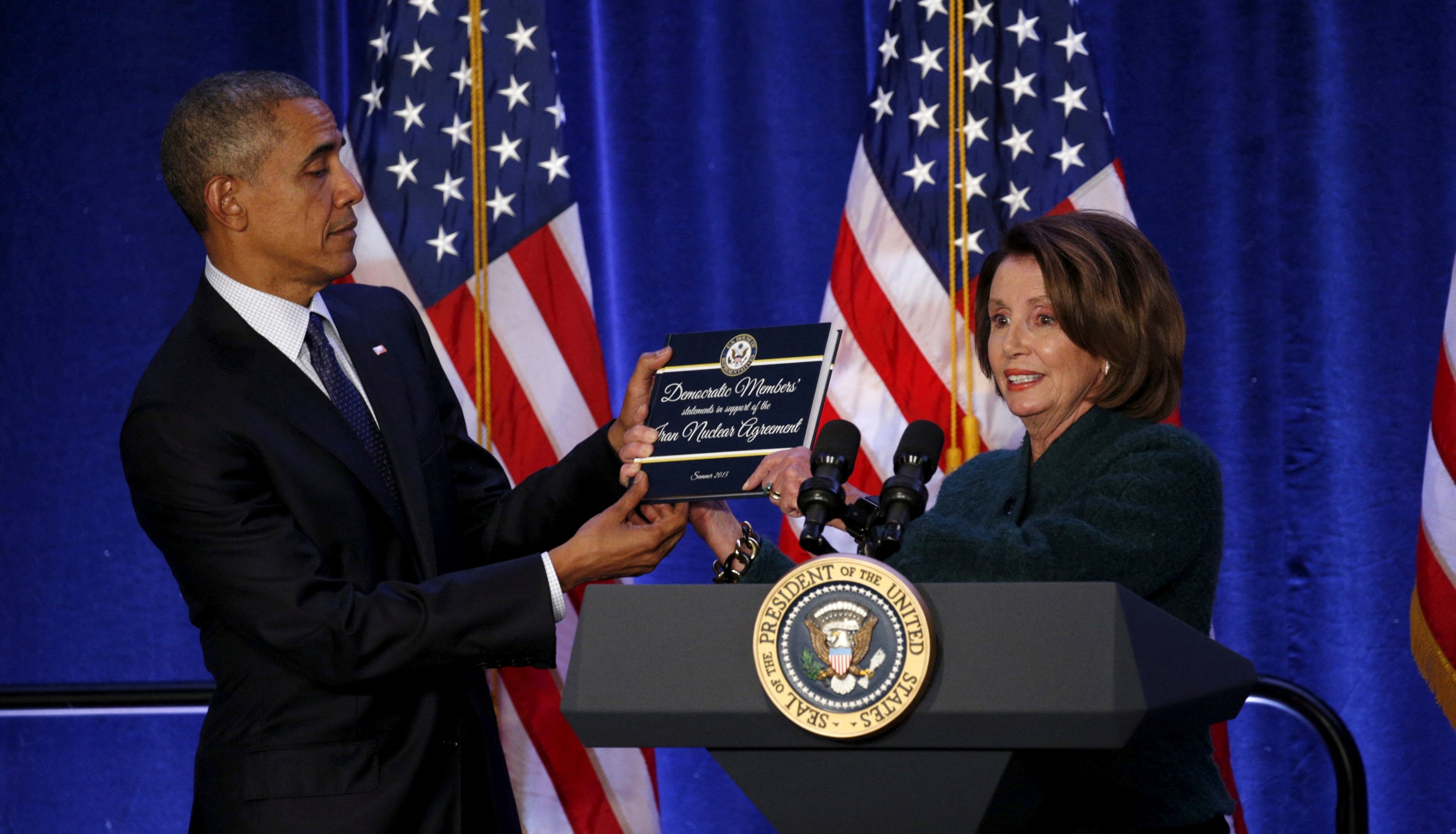 House Democratic leader Nancy Pelosi presents U.S. President Barack Obama with a book containing Democratic members' statements of support on the Iran nuclear agreement, during the House Democratic Issues Conference in Baltimore, Maryland, U.S., Jan. 28, 2016. (Reuters File Photo)