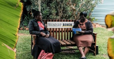 Counsellor "Gogo" Shery Ziwakayi (R) sits on a bench in conversation with a client during a private counselling session at the Friendship Bench in Harare, Zimbabwe, Nov. 2, 2022. (AFP Photo)