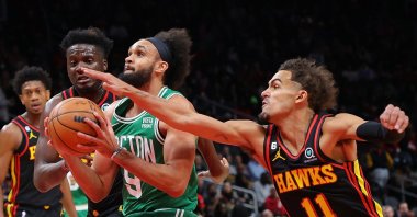 Derrick White of the Boston Celtics drives between Trae Young and Clint Capela of the Atlanta Hawks during the first half at State Farm Arena, Atlanta, Georgia, Nov. 16, 2022. (AFP Photo)