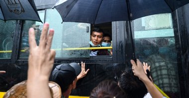 Relatives gather around a bus carrying prisoners being released outside the Insein prison, Yangon, Myanmar, Nov. 17, 2022. (AFP Photo)
