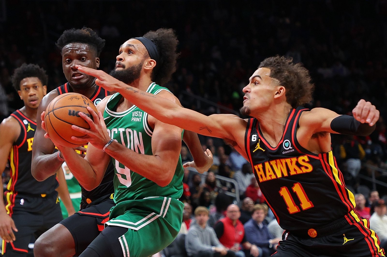 Derrick White of the Boston Celtics drives between Trae Young and Clint Capela of the Atlanta Hawks during the first half at State Farm Arena, Atlanta, Georgia, Nov. 16, 2022. (AFP Photo)