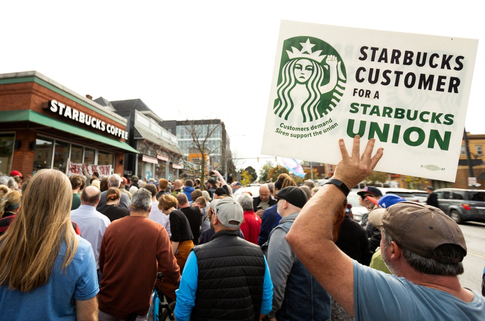 People gather outside a Starbucks location while singer Billy Bragg performs for striking Starbucks Workers United Union members in Buffalo, New York, U.S., Oct. 12, 2022. (Reuters Photo)