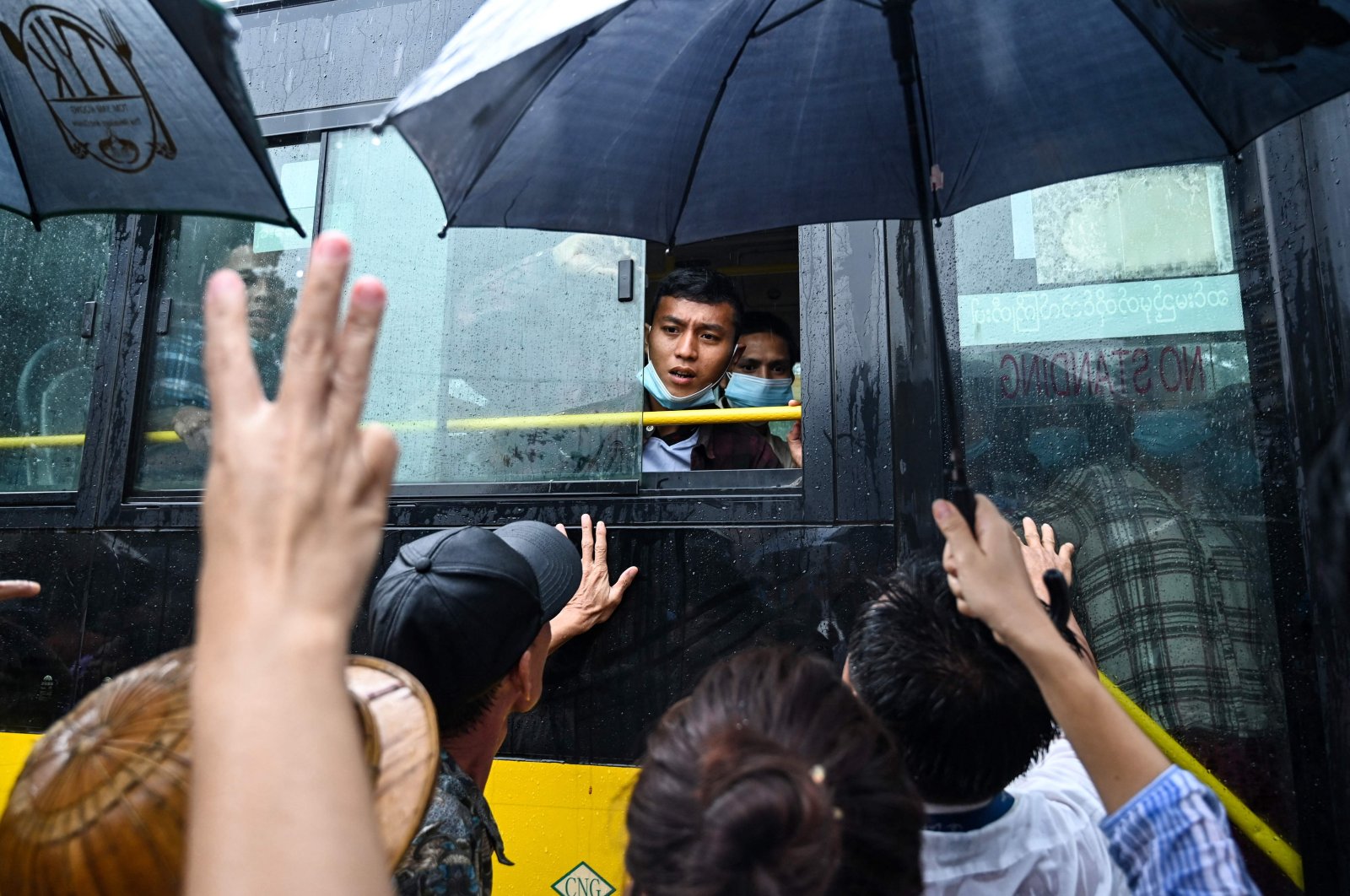 Relatives gather around a bus carrying prisoners being released outside the Insein prison, Yangon, Myanmar, Nov. 17, 2022. (AFP Photo)